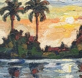 Palm trees at sunset over water